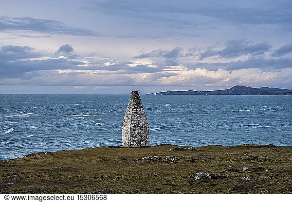 Cardigan Bay and stone cairn marking the entrance to Porthgain Harbour from the Pembrokeshire Coast Trail  Pembrokeshire National Park  Wales  UK.