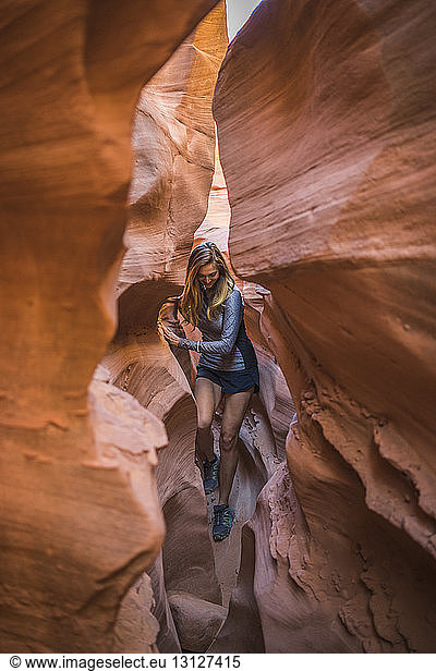 Carefree female hiker amidst canyons