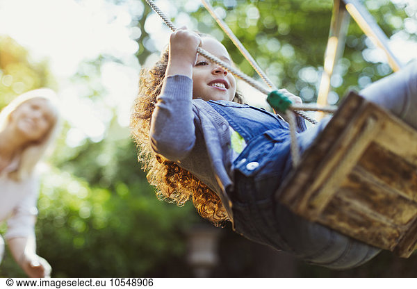 Carefree girl swinging in park