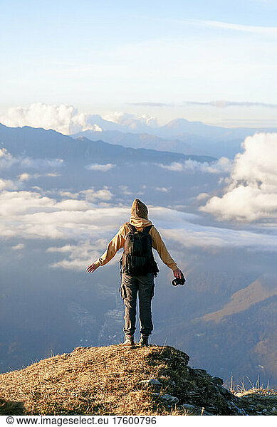 Carefree tourist standing at cliff on mountain at Caucasus Nature Reserve in Sochi  Russia