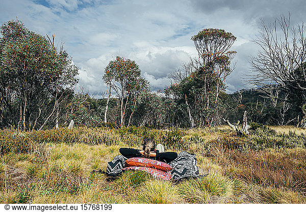Carefree woman relaxing in woods Alpine National Park Australia