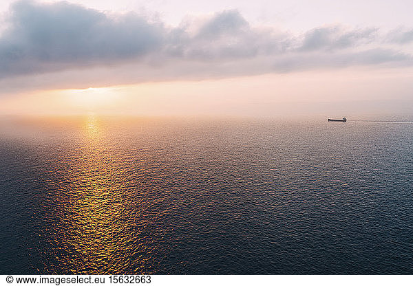 Cargo ship sailing towards sunset at horizon  Mallorca  Spain