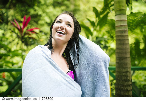 Caribbean Islands  Saint Lucia  Woman with wet hair wrapped in towel with lush foliage in background