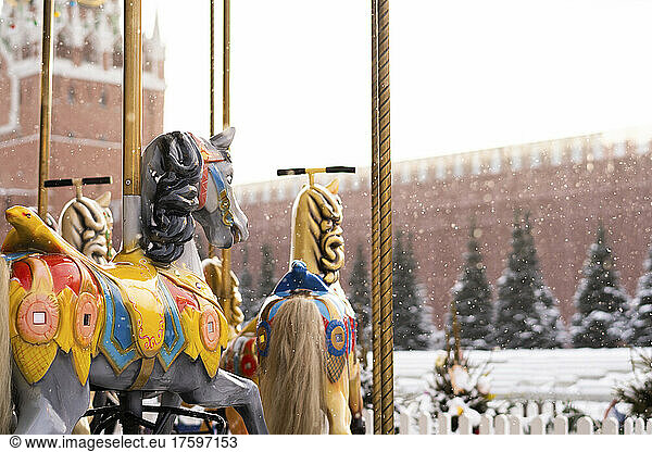 Carousel horses ride at Christmas market in winter