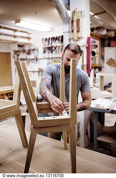 Carpenter polishing stool at workshop