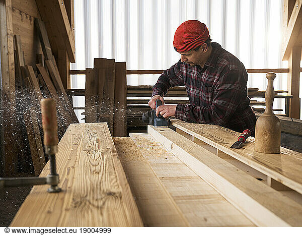 Carpenter working with hand tool at workshop