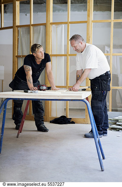 Carpenters working together at workshop
