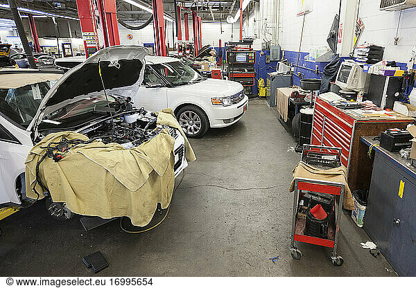 Cars and machinery in an auto repair shop.