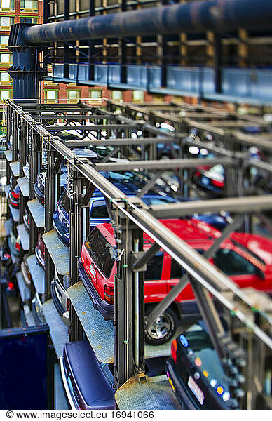 Cars stored in large metal lift.