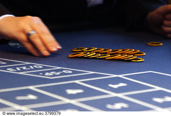 Casino in Berlin center. Hands when sorting chips at the roulette table.