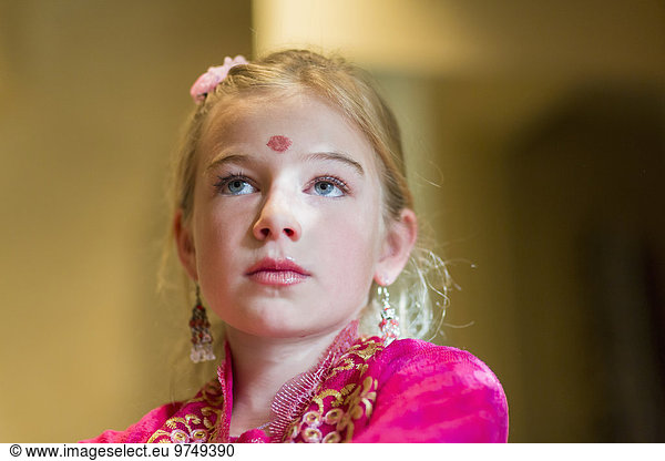 Caucasian girl wearing bindi on forehead