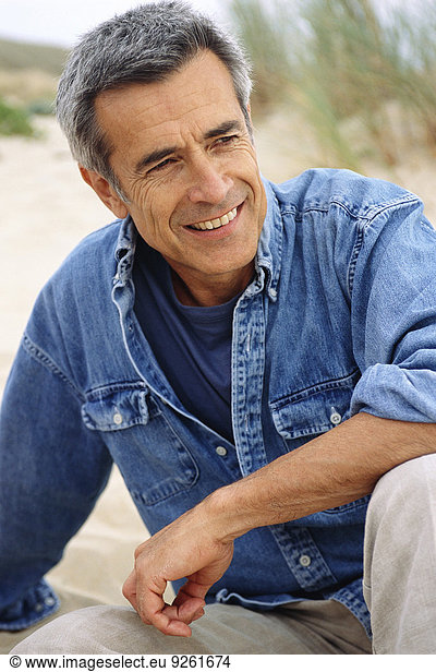 Caucasian man smiling on beach
