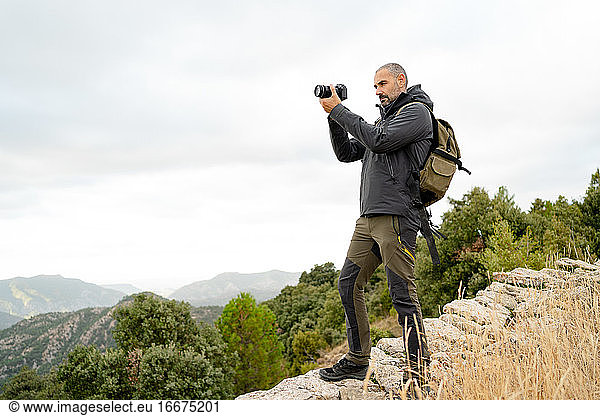 caucasian man Traveler with photo camera and backpack
