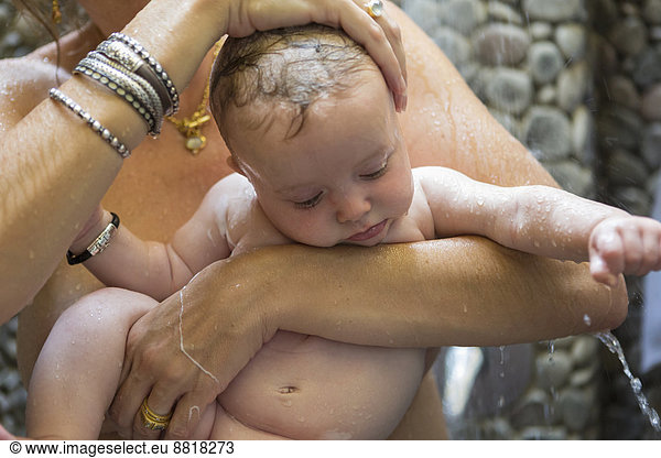 Caucasian mother and baby taking shower