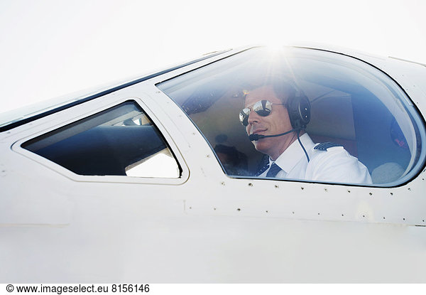 Caucasian pilot in airplane cockpit