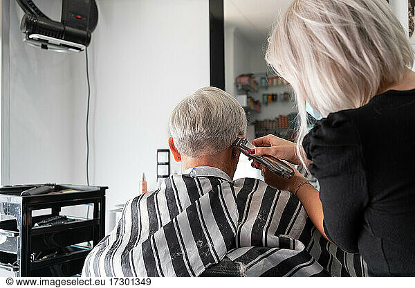 Caucasian senior white haired woman in hair salon
