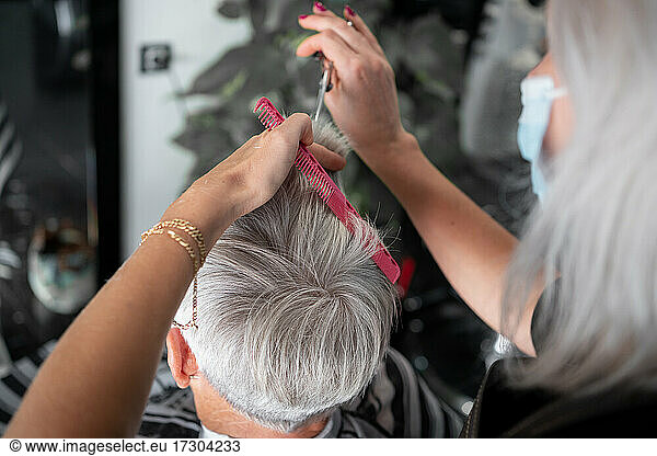 Caucasian senior white haired woman in hair salon
