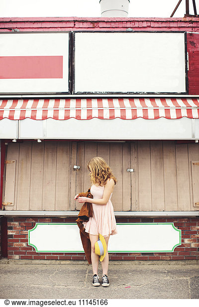 Caucasian teenage girl standing outside pizzeria