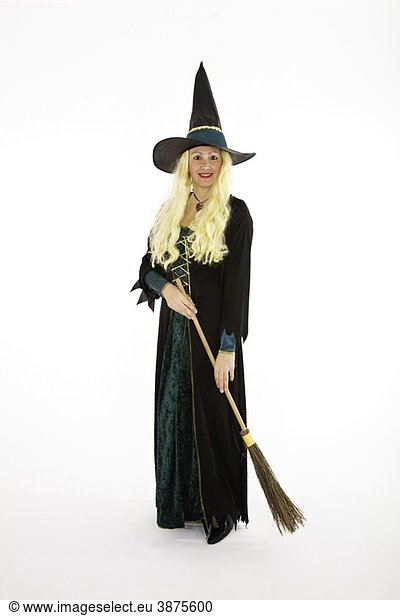 Caucasian woman dressed as a scary witch standing on white background