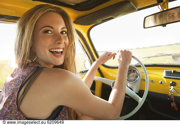 Caucasian woman driving old-fashioned car