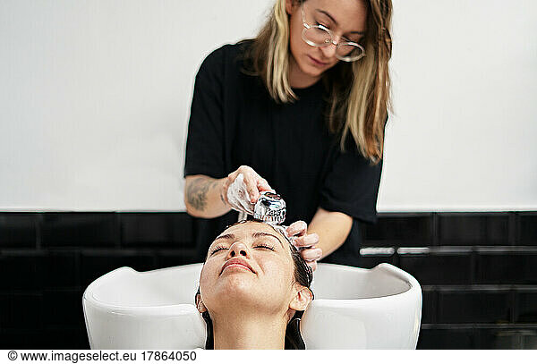 Caucasian woman getting her hair washed