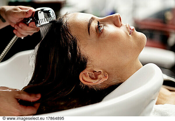 Caucasian woman getting her hair washed