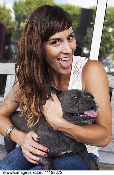 Caucasian woman imitating dog with tongue out