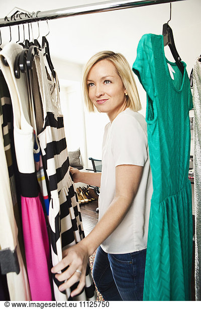 Caucasian woman searching in wardrobe