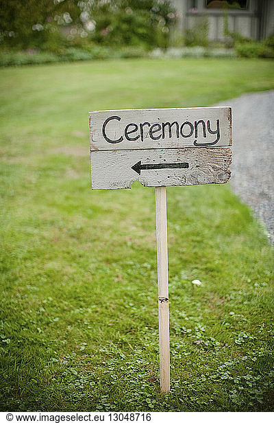 Ceremony text on wooden plank at field