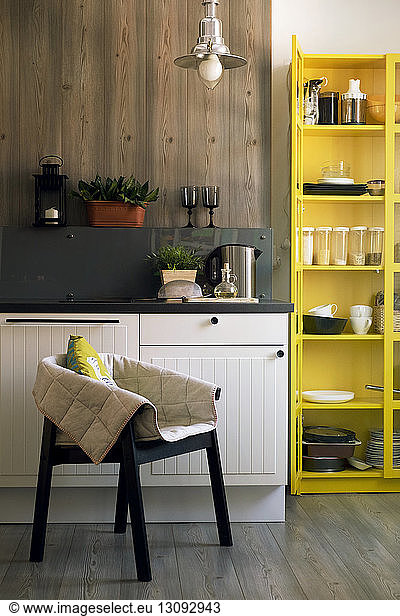 Chair and yellow cabinet in domestic kitchen