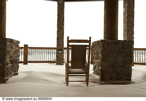 Chair on a Snowy Balcony