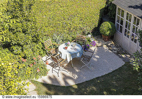 Chairs and table set in springtime backyard