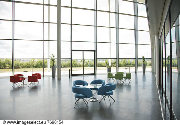 Chairs and tables in office lobby area
