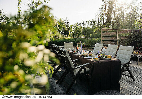 Chairs and tables with food arranged in back yard