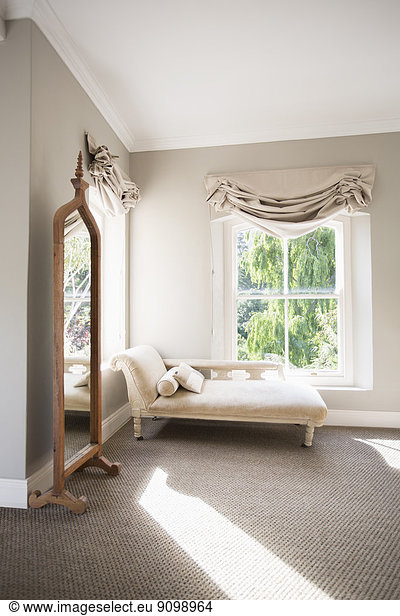Chaise in sunny luxury bedroom