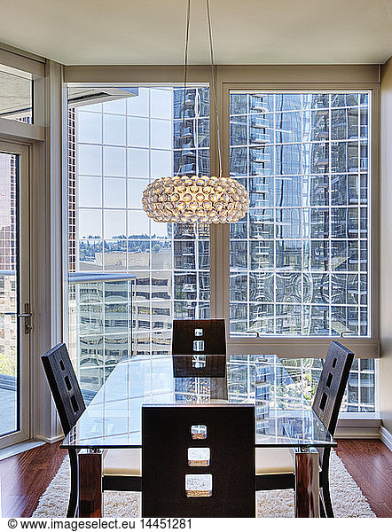 Chandelier over dining room in luxury highrise apartment