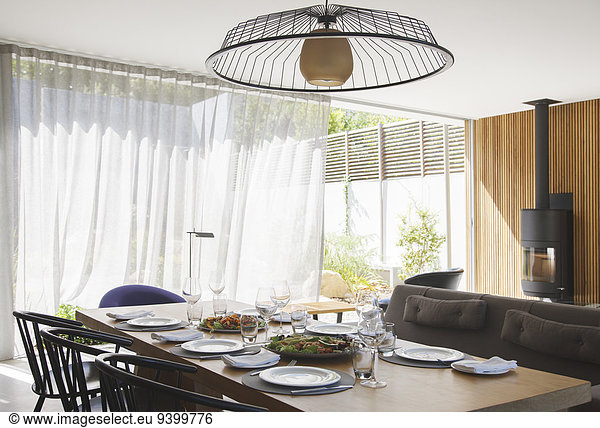 Chandelier over dining table in modern dining room