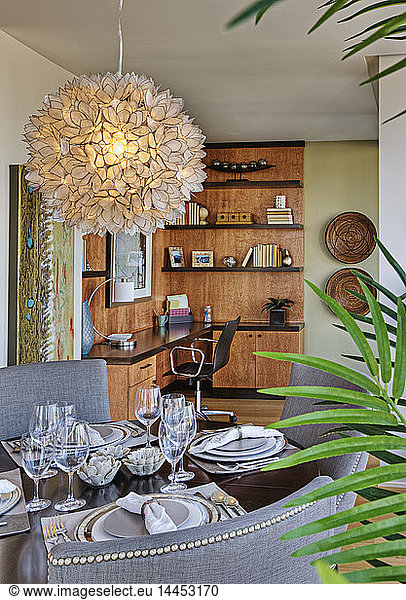 Chandelier over luxury dining room table