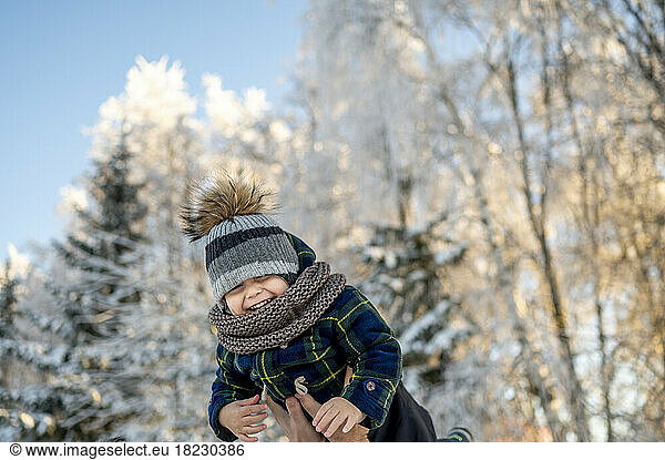 Cheerful boy enjoying at winter park