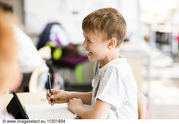 Cheerful boy in classroom at school