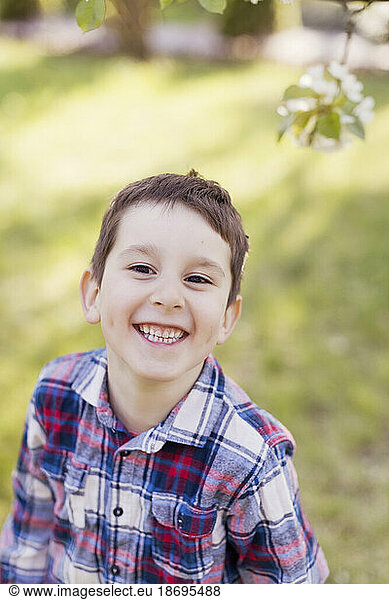 Cheerful boy smiling at backyard