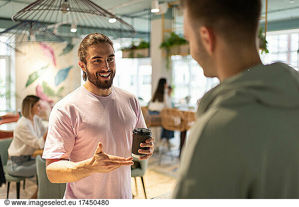 Cheerful client talking with barista