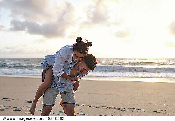 Cheerful couple having fun at beach