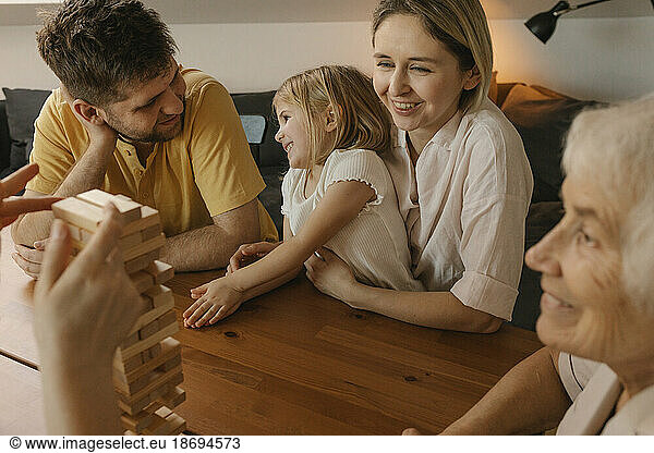 Cheerful family playing leisure game at home