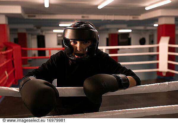 Cheerful female boxer in protective gear