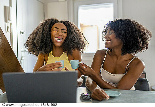 Cheerful freelancers having coffee and working at home