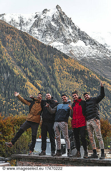 Cheerful friends standing in front of mountain  Chamonix  France