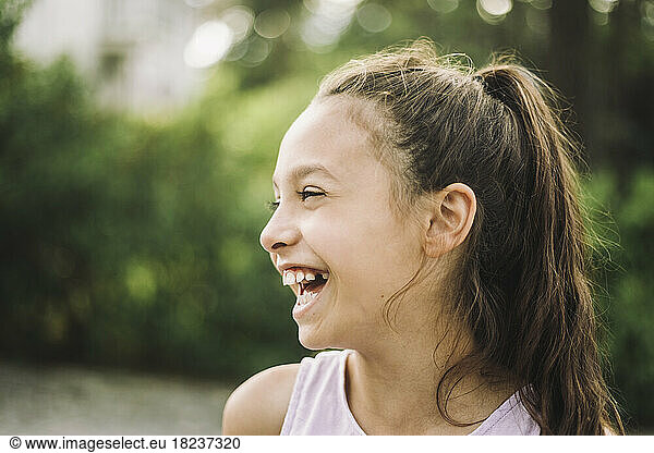 Cheerful girl looking away and laughing