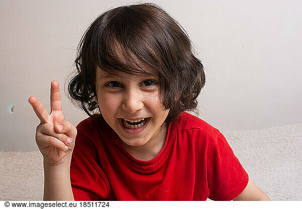 Cheerful little boy with Victory Hand Sign as Victory concept