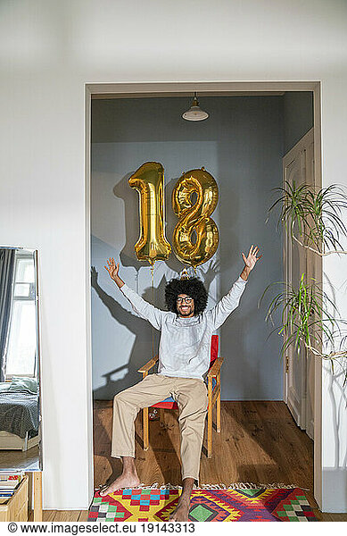 Cheerful man celebrating birthday at home